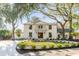 Stunning two-story home with a white brick exterior, balcony, manicured lawn, and mature trees at 19 Ponce De Leon Ave, Charleston, SC 29407