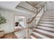Spacious foyer with hardwood floors, staircase with white railing, and an open view to the living areas at 19 Ponce De Leon Ave, Charleston, SC 29407