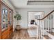 Inviting foyer featuring hardwood floors, staircase, and a decorative potted plant near the front doors at 19 Ponce De Leon Ave, Charleston, SC 29407