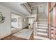 Bright foyer with hardwood floors, staircase, and views into adjacent living spaces at 19 Ponce De Leon Ave, Charleston, SC 29407