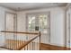 Second floor hallway with wood floors, white walls, and a set of glass pane double doors at 19 Ponce De Leon Ave, Charleston, SC 29407