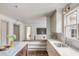 Bright kitchen featuring marble countertops, white cabinetry, stainless steel sink, and hardwood floors at 19 Ponce De Leon Ave, Charleston, SC 29407