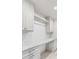 Bright laundry room featuring classic white cabinets and sleek marble countertop at 19 Ponce De Leon Ave, Charleston, SC 29407