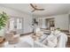 Bright living room with white furniture, modern decor, and view into foyer at 19 Ponce De Leon Ave, Charleston, SC 29407