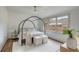 Tranquil main bedroom with a canopy bed, hardwood floors, and large windows at 19 Ponce De Leon Ave, Charleston, SC 29407