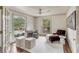 Bright and airy office space with a large window view, comfortable seating, and decorative touches at 19 Ponce De Leon Ave, Charleston, SC 29407