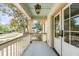 Charming porch features a light blue ceiling, white railing, and a view of the neighborhood at 19 Ponce De Leon Ave, Charleston, SC 29407