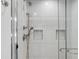 Modern shower featuring white tiled walls and a frameless glass door at 19 Ponce De Leon Ave, Charleston, SC 29407