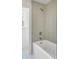 Bathroom with gray tiled shower-tub combination and a window at 19 Ponce De Leon Ave, Charleston, SC 29407