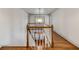Wide view of the staircase landing with wood railing, floors, and white walls at 19 Ponce De Leon Ave, Charleston, SC 29407