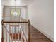 Staircase featuring wood handrail, white risers, and a globe pendant light at 19 Ponce De Leon Ave, Charleston, SC 29407