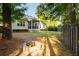 Large, grassy backyard with a cozy fire pit and a screened in porch and wooded surroundings at 1971 N Smokerise Way, Mount Pleasant, SC 29466