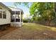 Expansive backyard with a patio, screened-in porch, and mature trees at 1971 N Smokerise Way, Mount Pleasant, SC 29466