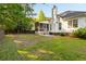 Lush backyard with a screened porch, a patio, and plenty of space for activities at 1971 N Smokerise Way, Mount Pleasant, SC 29466