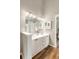 Bathroom with double sink vanity, modern lighting, and wood-look floors at 1971 N Smokerise Way, Mount Pleasant, SC 29466