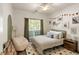 Cozy bedroom with a large window, patterned rug, and comfortable beanbag chair at 1971 N Smokerise Way, Mount Pleasant, SC 29466
