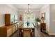 Formal dining room with elegant lighting, vintage cabinet and seating for eight at 1971 N Smokerise Way, Mount Pleasant, SC 29466
