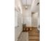 Inviting foyer with tiled floors, white trim, wooden bench, decorative baskets, and modern light fixture at 1971 N Smokerise Way, Mount Pleasant, SC 29466