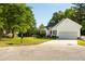 Charming home with a well-manicured lawn, long driveway, and inviting red door at 1971 N Smokerise Way, Mount Pleasant, SC 29466