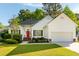 Charming one-story home with a well-manicured lawn, brick entryway, and a bright red front door at 1971 N Smokerise Way, Mount Pleasant, SC 29466