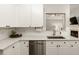 Close-up of kitchen featuring white cabinets, stainless steel dishwasher, and modern countertops at 1971 N Smokerise Way, Mount Pleasant, SC 29466