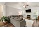 Bright living room features a sectional sofa, ceiling fan, a fireplace, and large windows at 1971 N Smokerise Way, Mount Pleasant, SC 29466