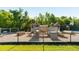 Community playground with wooden play structures and climbing features, surrounded by lush greenery and a secure fence at 1971 N Smokerise Way, Mount Pleasant, SC 29466