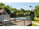 Playground and basketball court surrounded by lush greenery; a perfect outdoor recreation space for Gathering fun at 1971 N Smokerise Way, Mount Pleasant, SC 29466