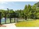 Fenced community tennis courts with manicured landscaping at 1971 N Smokerise Way, Mount Pleasant, SC 29466
