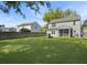Well-maintained backyard featuring a grassy lawn, firepit, wooden fence, and screened-in porch at 2016 Elvington Rd, Johns Island, SC 29455