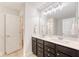 Bathroom featuring double vanity with dark cabinets, modern lighting, and mirrors at 2016 Elvington Rd, Johns Island, SC 29455