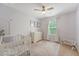 Bright Bedroom boasts plush carpet, window, ceiling fan, and a white crib at 2016 Elvington Rd, Johns Island, SC 29455