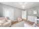 Neutral Bedroom offers plush chair, changing table, and elegant chandelier at 2016 Elvington Rd, Johns Island, SC 29455
