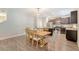 Open dining area with modern lighting fixture and wood table with chairs at 2016 Elvington Rd, Johns Island, SC 29455