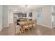 Open dining area with modern lighting fixture and wood table with chairs at 2016 Elvington Rd, Johns Island, SC 29455