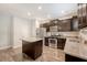 Open dining area with modern lighting fixture and wood table with chairs at 2016 Elvington Rd, Johns Island, SC 29455