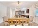 Open dining area with modern lighting fixture and wood table with chairs at 2016 Elvington Rd, Johns Island, SC 29455