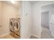Bright laundry room offers stainless steel washer and dryer at 2016 Elvington Rd, Johns Island, SC 29455
