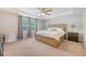 Bright primary bedroom with a tray ceiling, ceiling fan, and large windows at 2016 Elvington Rd, Johns Island, SC 29455