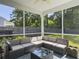 Inviting screened-in patio with comfortable seating and a tranquil view of the lush backyard at 2016 Elvington Rd, Johns Island, SC 29455