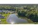 Expansive aerial view showcasing a serene lake surrounded by lush greenery and beautiful homes in a community at 203 Eagle Ridge Rd, Summerville, SC 29485
