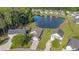 Scenic aerial view of a lovely home with a private pond, nestled among lush greenery and neighboring houses at 203 Eagle Ridge Rd, Summerville, SC 29485
