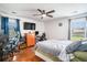 Spacious bedroom featuring a ceiling fan, hardwood floors, and natural light from two windows at 203 Eagle Ridge Rd, Summerville, SC 29485