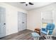 Neutral bedroom featuring gray wood floors, ceiling fan, and a glider chair at 203 Eagle Ridge Rd, Summerville, SC 29485