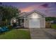 Charming single-story home at dusk with a well-maintained lawn, front porch, and attached garage at 203 Eagle Ridge Rd, Summerville, SC 29485