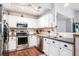 Modern kitchen with stainless steel appliances, white cabinets, and a functional layout at 203 Eagle Ridge Rd, Summerville, SC 29485