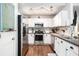 Bright kitchen features stainless steel appliances, white cabinetry and modern track lighting at 203 Eagle Ridge Rd, Summerville, SC 29485