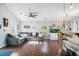 Open-concept living room with wood floors, neutral decor, and a bar area for entertaining at 203 Eagle Ridge Rd, Summerville, SC 29485