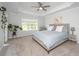Spacious main bedroom featuring a ceiling fan, cozy chair by the window, and light carpet flooring at 203 O'Malley Dr, Summerville, SC 29483