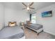 Charming ' bedroom with two twin beds, playful decor, ceiling fan, and a TV showing the beach at 203 O'Malley Dr, Summerville, SC 29483